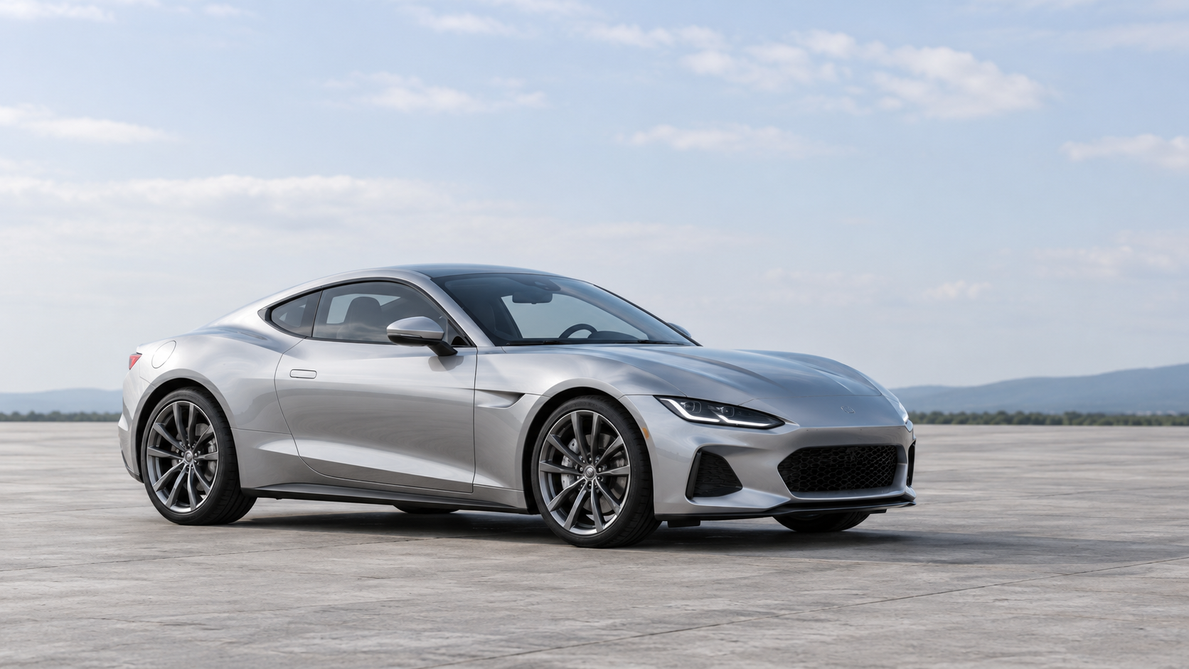 Silver sports coupe fully visible in a wide, uncluttered frame with open space above and ahead.